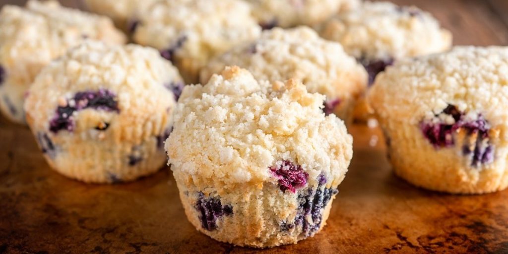 multiple high altitude blueberry muffins with streusel topping