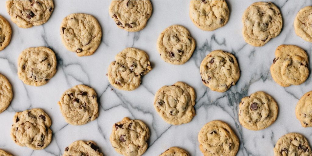 brown butter chocolate chip cookies laid out evenly on a white marble countertop