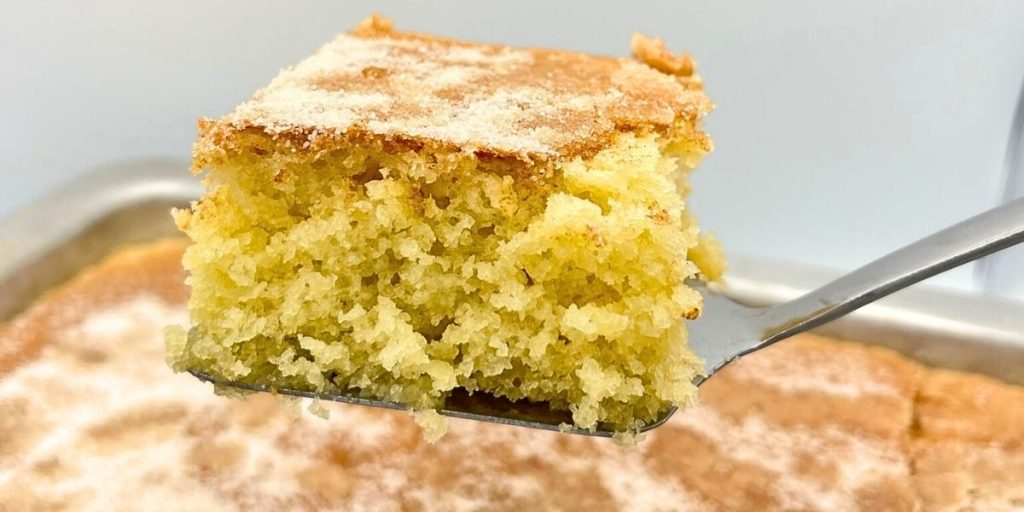 a slice of high altitude coffee cake with cinnamon sugar topping on a spatula