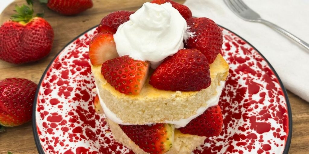 single serving of high altitude strawberry shortcake with 2 layers of cake with fresh strawberries and whipped cream in between and on top