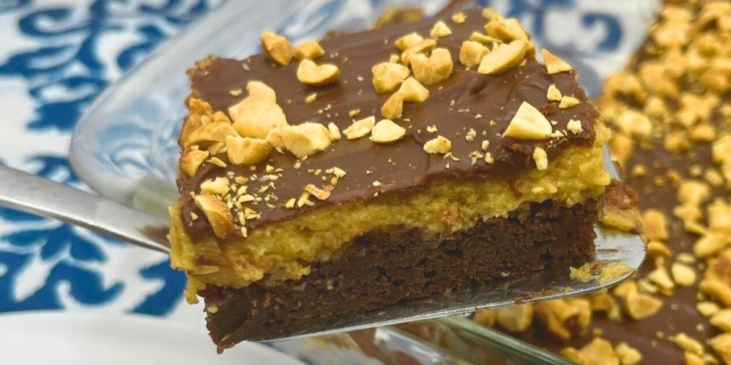 a slice of triple layer peanut butter brownies on a spatula