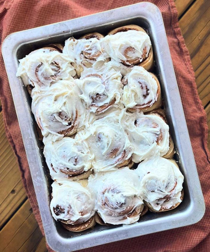 a 9x13 pan of high altitude sourdough cinnamon rolls with vanilla frosting